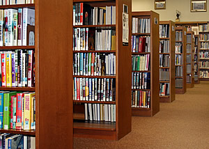 library bookshelves, symbolising information about Assessability Limited and its work as an expert witness and care cost consultant